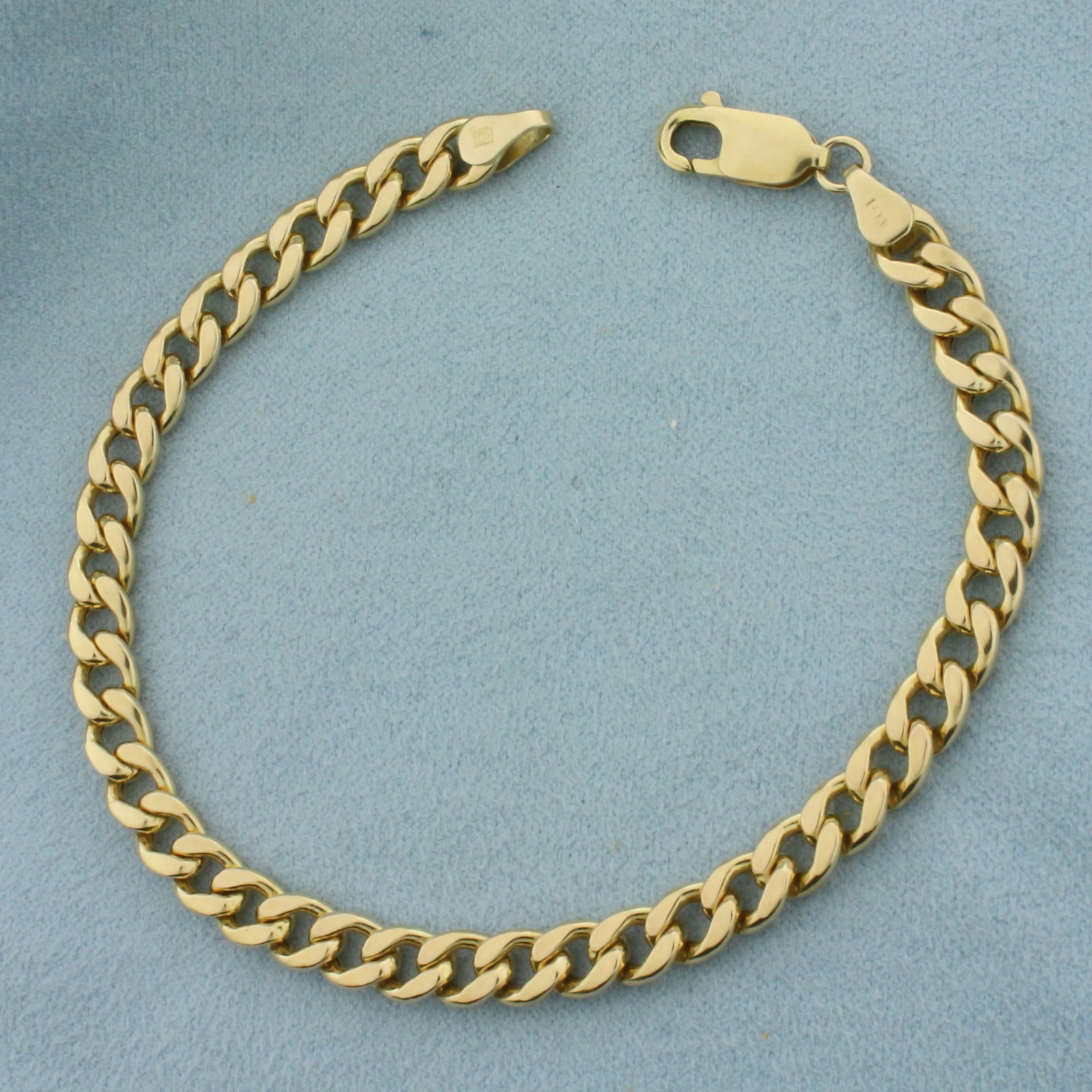 Curb Link Bracelet in 14K Yellow Gold: In 14k yellow gold. 8 inches long by 5.6mm wide. Lobster clasp. 7.0g.
