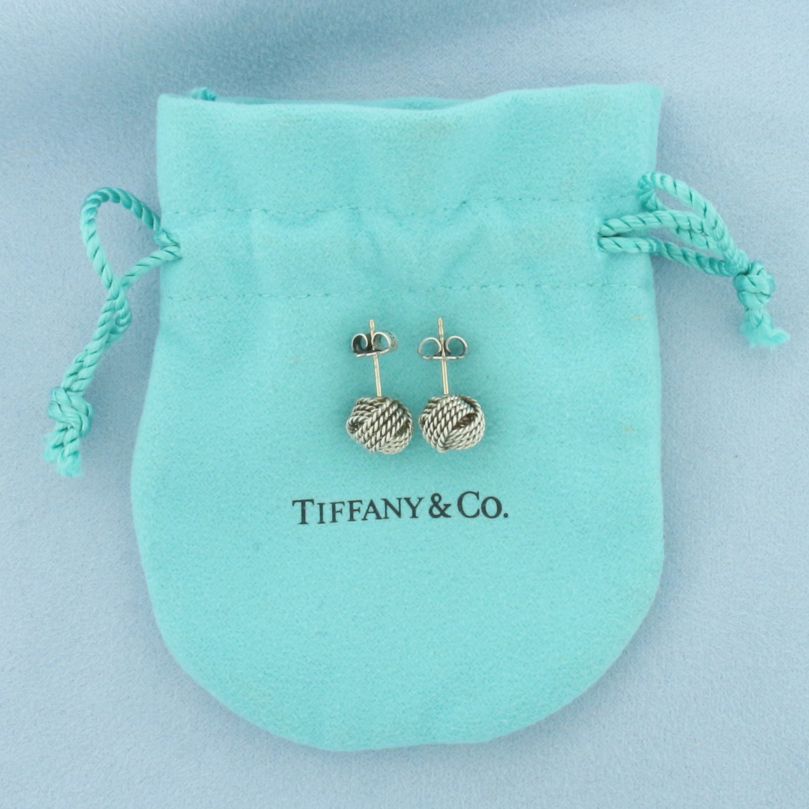 Tiffany and Co Somerset Braided Twist Knot Earrings in Sterling Silver: In .925 sterling silver. 9mm wide with original backs. Pouch included.