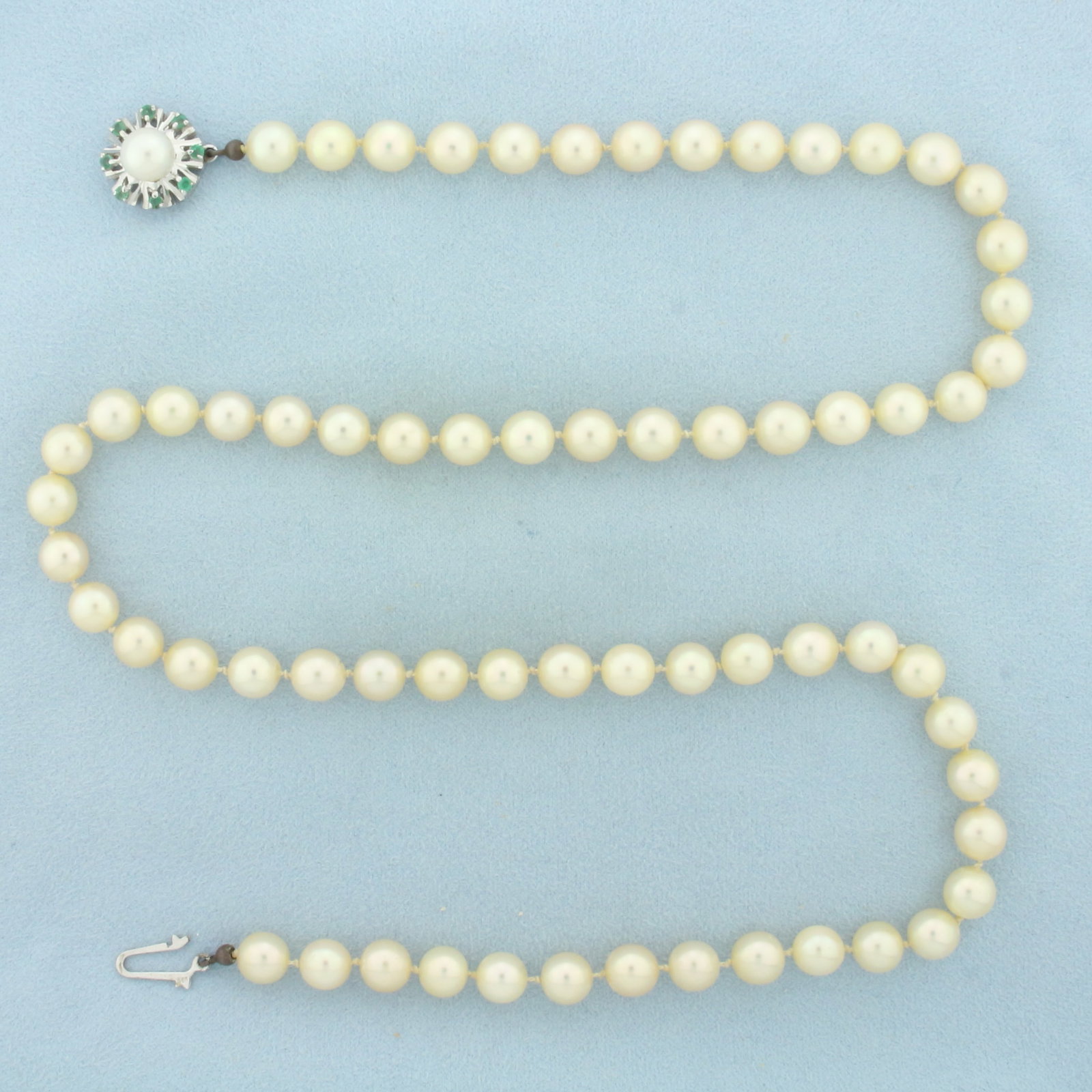 Emerald and Cultured Akoya Pearl Strand Necklace in 14K White Gold: 14k white gold decorative locking slide clasp. 23 inches long, 15.4mm diameter on clasp. Contains high quality 7.5-7.75mm Cultured Akoya Pearls with high luster and creamy color, hand knotted. Accente