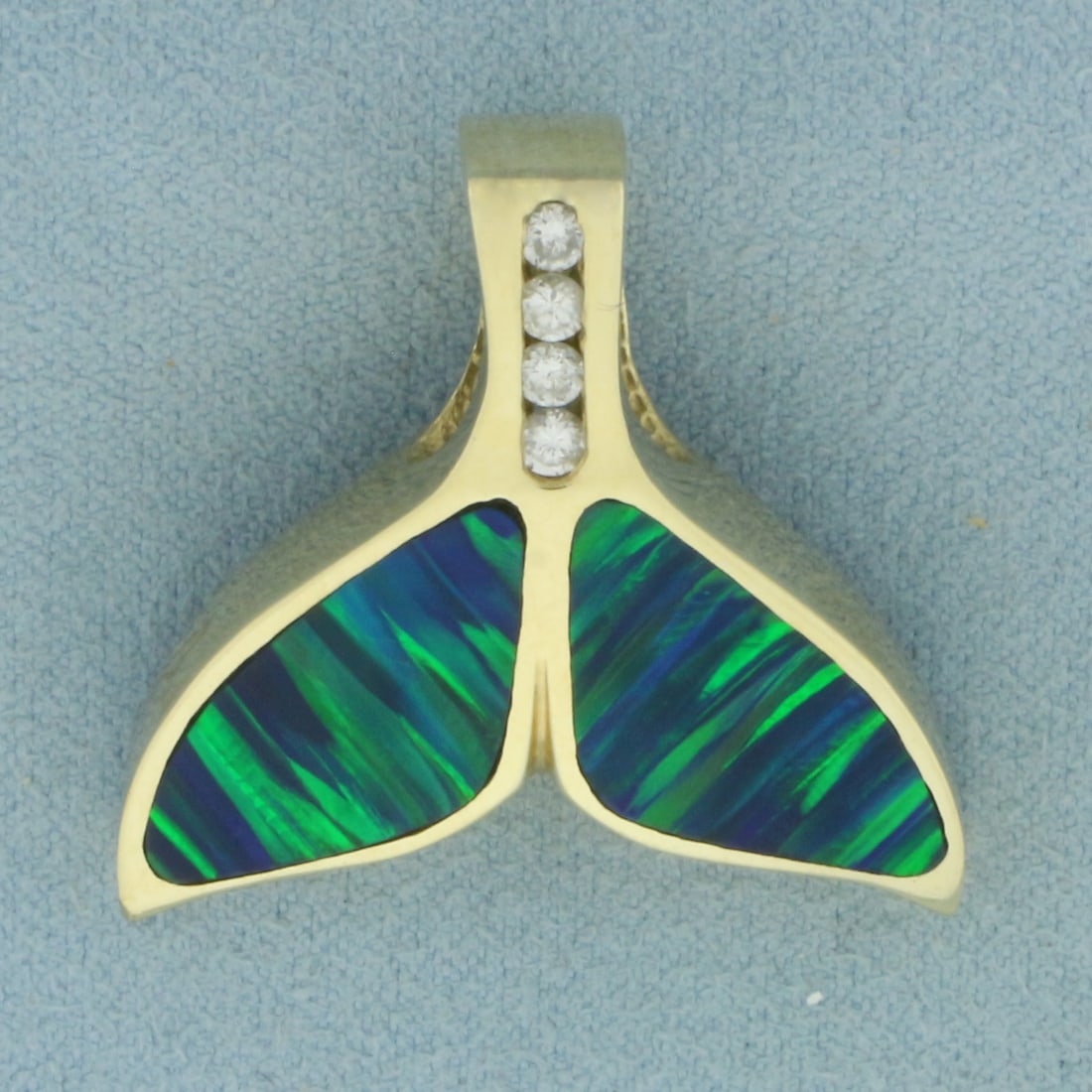 Diamond and Opal Inlay Whale Tail Pendant in 14k Yellow gold: In 14k yellow gold 1 inch long by 1 1/8 inches wide. Contains 4 high quality natural 0.08ct diamonds, SI clarity/G color. Accented with 2 high quality 12mm Opal gemstones inlaid into the pendant with 
