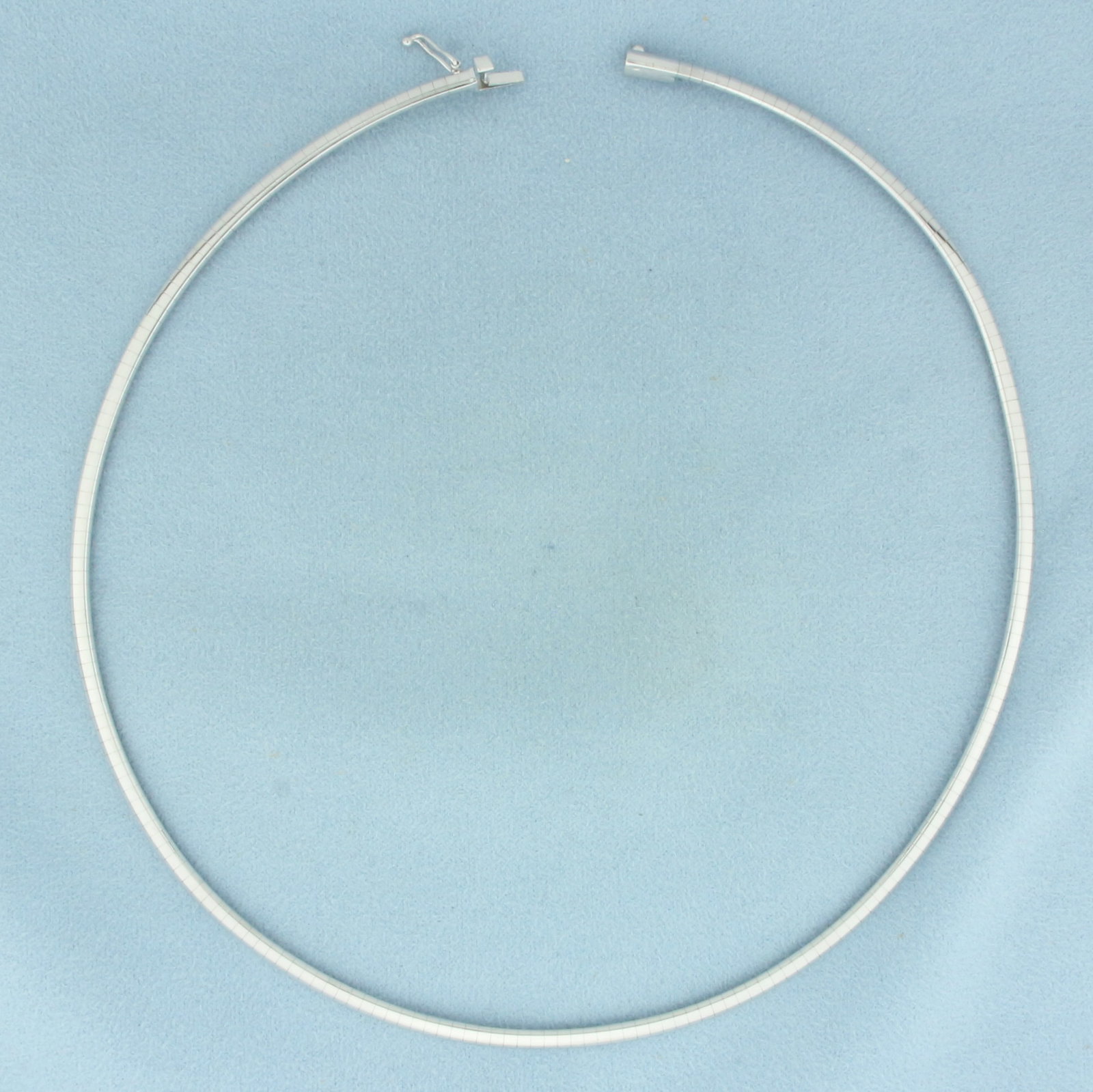16 Inch Italian Omega Link Necklace in 14K White Gold: In 14k white gold. 16 inch long by 3mm wide. Italian made. Concealed slide closure with safety latch. 18.7g.