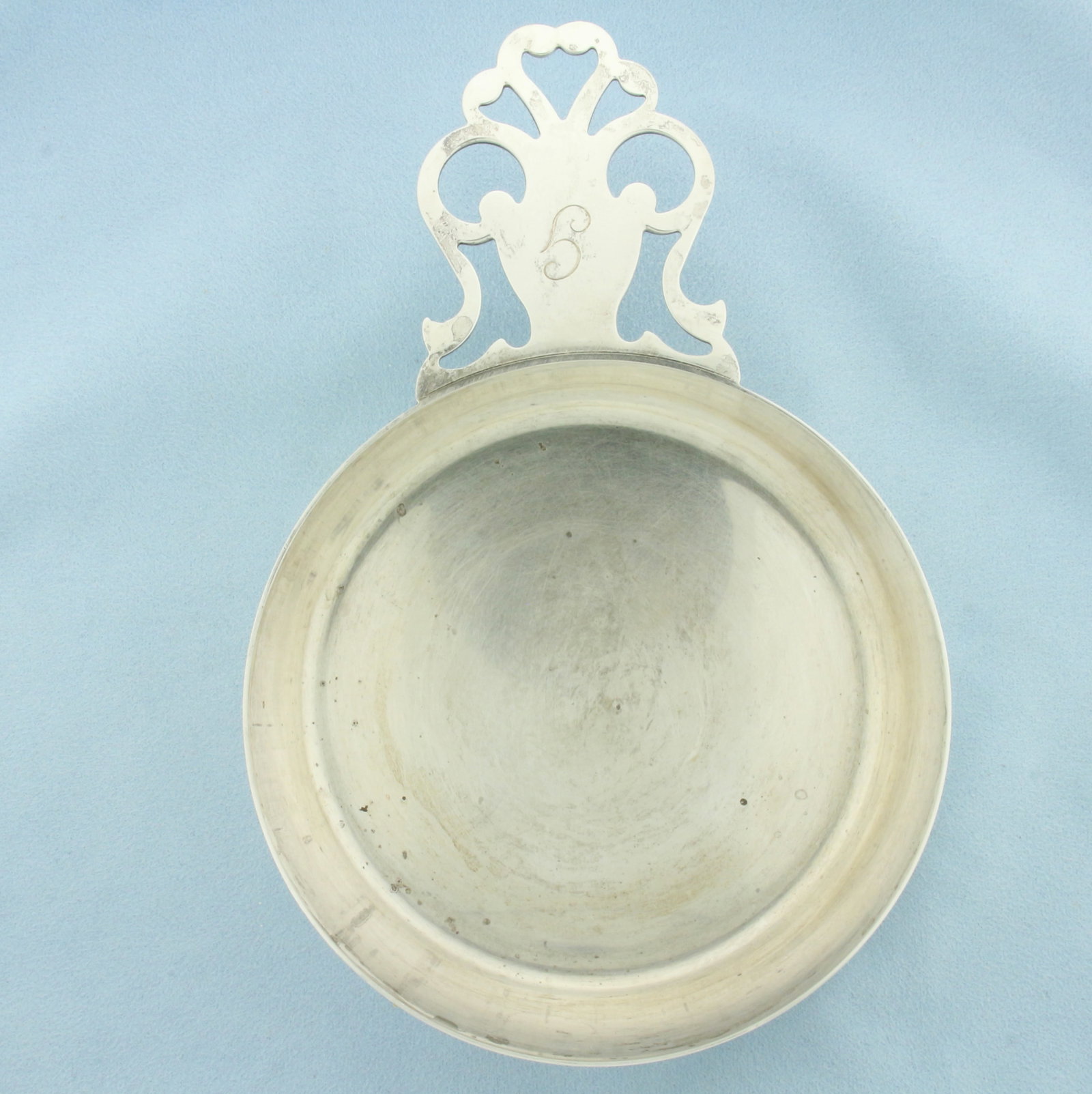 Tiffany and Co Large Porringer Bowl in Sterling Silver: In .925 sterling silver. Signed Tiffany & Co. Model 5796. Measures 6 1/2 inches long by 4 3/8 inches wide. Light "g" monogram. 229.1g.