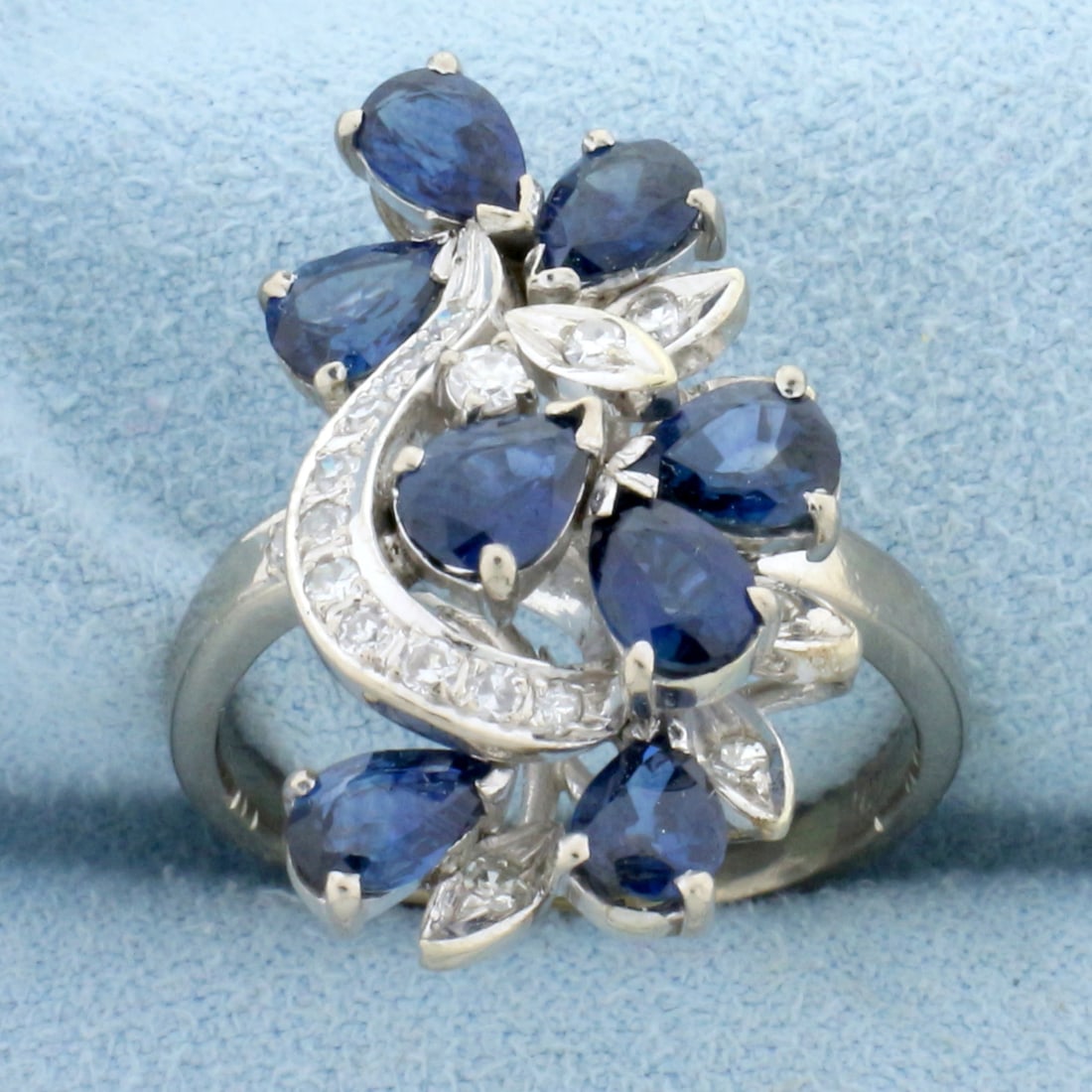 Designer Sapphire and Diamond Statement Ring in 14K White Gold: In 14K White Gold. Contains eight AAA quality natural 6 x 4mm pear cut Sapphire gemstones with vibrant blue color and excellent clarity. Also contains nineteen high quality round cut Diamonds, 1/3ct T