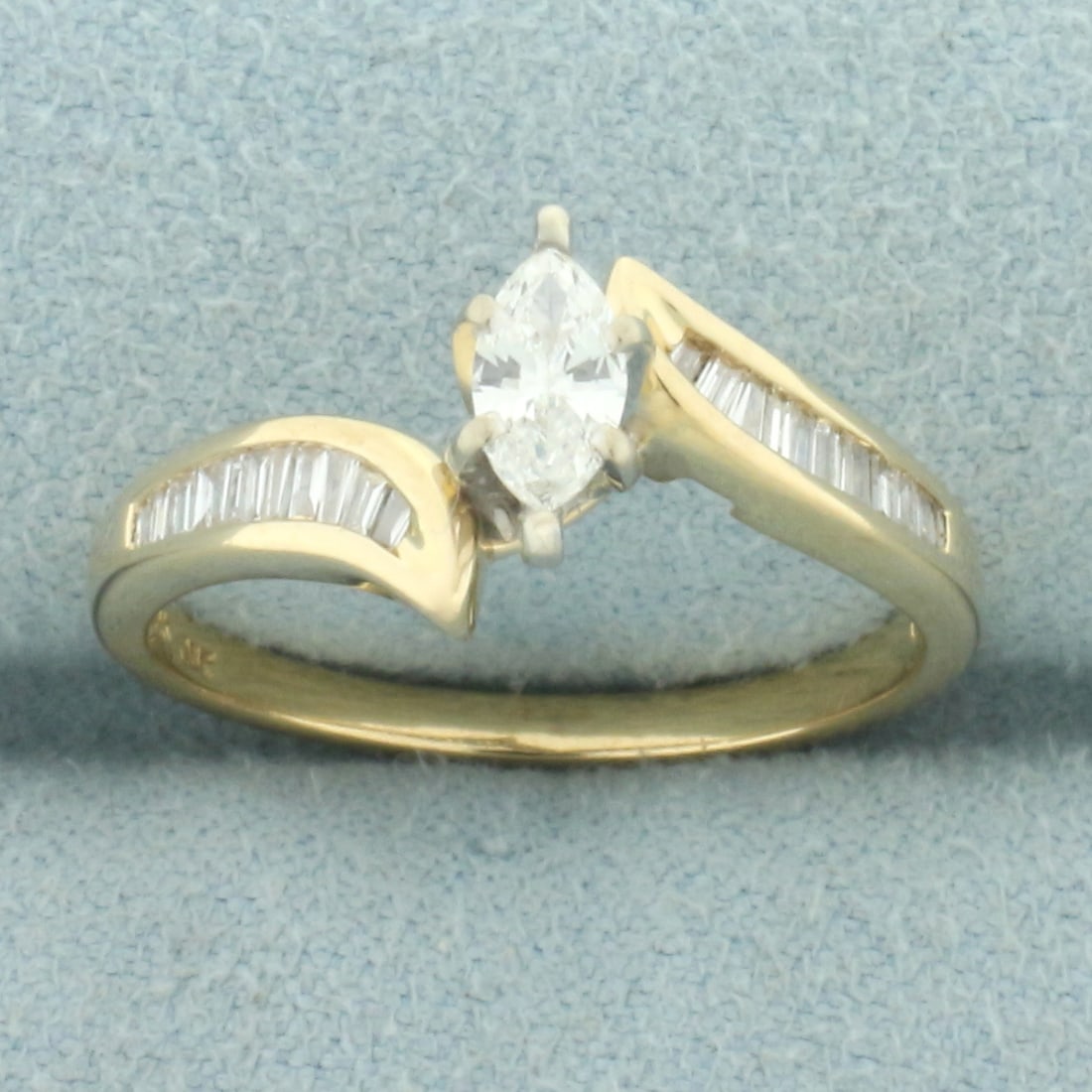 Marquise and Baguette Diamond Engagement Ring in 14k Yellow Gold: In 14k yellow gold. Contains one high quality 6.3mm marquise diamond, 1/3ct, VS clarity/H color. Also contains twenty-two high quality baguette diamonds, 1/4ct TW, of similar high quality. Size: 7.25.