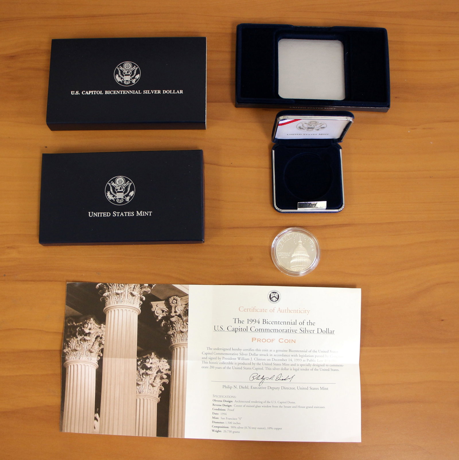 US Mint US Capitol Bicentennial Proof Silver Dollar Coin OGP: Contains one 1994 U.S. Capitol Commemorative Silver Dollar. Includes CoA, original packaging and box.