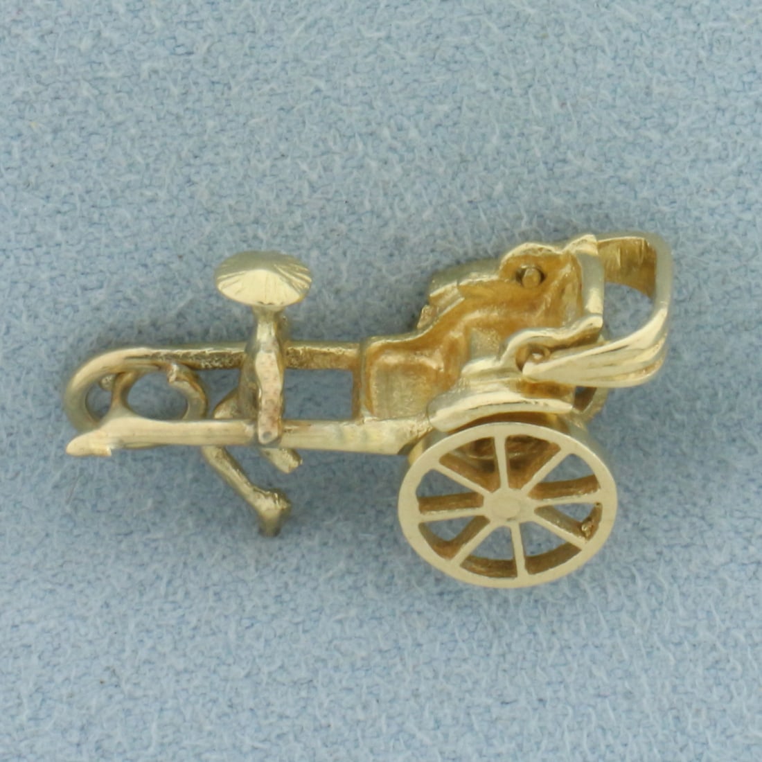 Mechanical Rickshaw Charm or Pendant in 14k Yellow Gold: In 14k Yellow Gold. 3/4 inch long. 1/2 inch wide at widest. Wheels and canopy move. 3.3g.