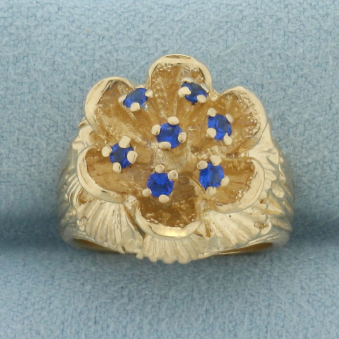 Spinel Flower Ring in 10K Yellow Gold: In 10k yellow gold. 15mm wide at top of ring. Contain 7 high quality Spinel Gemstones, 2mm each, with bright color and excellent clarity. Size 5. 7.6g.