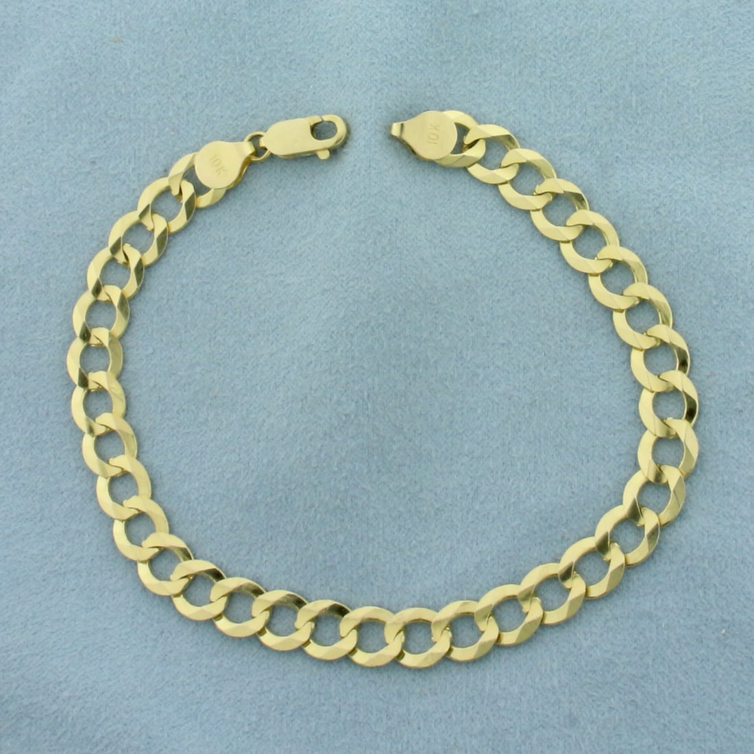 Curb Link Bracelet in 10k Yellow Gold: In 10k yellow gold. 8 inches long, 7mm wide. Lobster clasp. 8.9g.