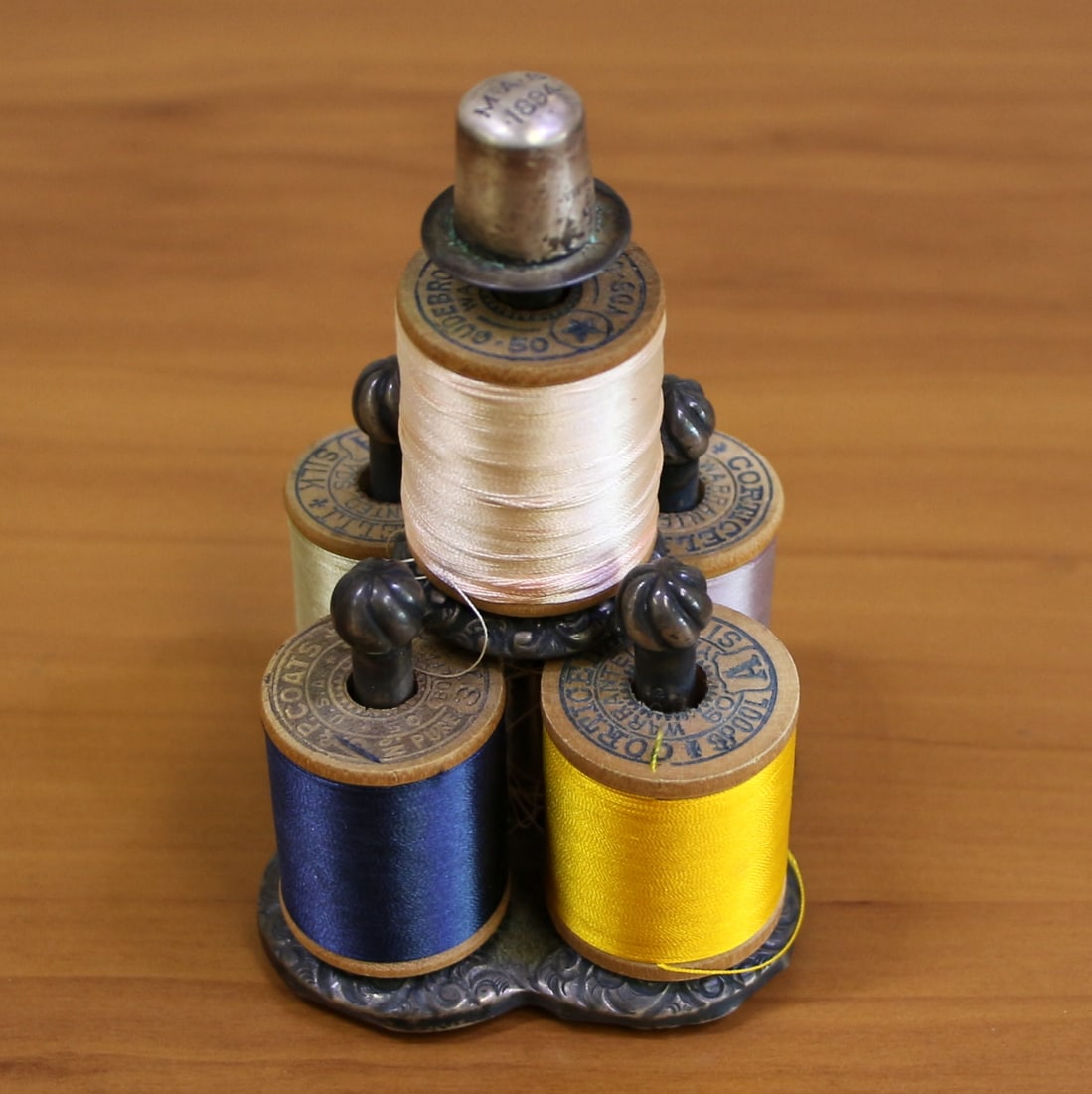 Antique Victorian Circa 1894 Thread Spool Holder in Sterling Silver: In .925 Sterling Silver. Includes 5 Corticelli Silk Thread Spools. Crica 1894. Engraved. 4 inches tall, 2.75 inches wide. 95.4g with thread.