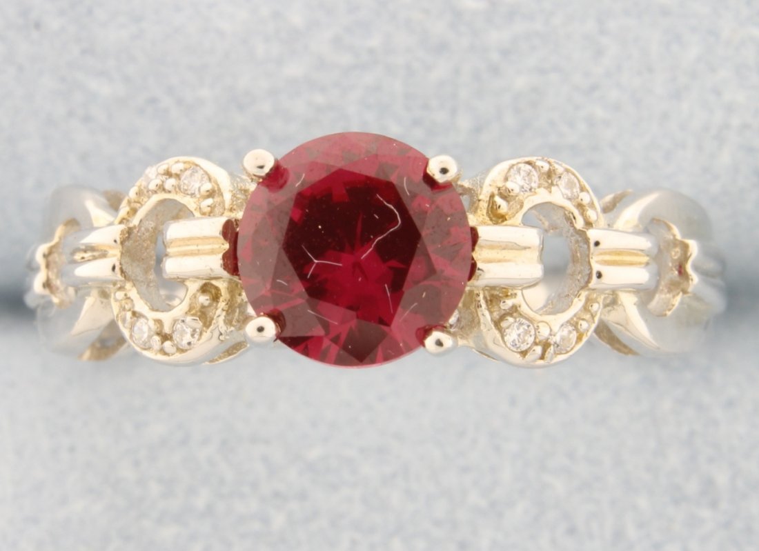 Sterling silver ring with beautiful lab Ruby: Stunning sterling silver ring with gorgeous round cut lab Ruby center accented with white sapphires sparkling in a stylish setting 3.5g