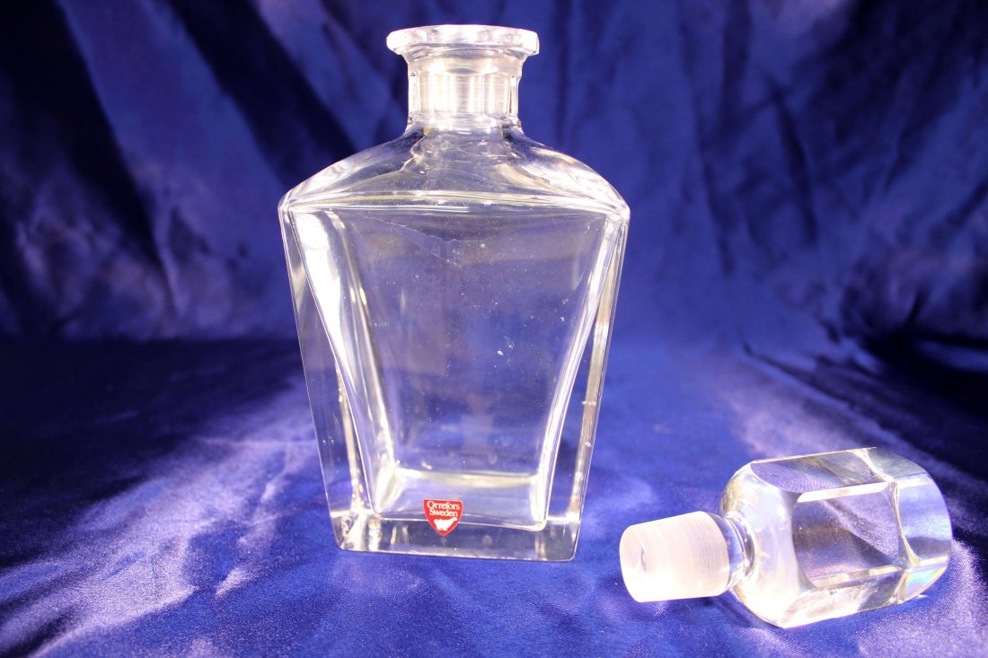 Orrefors Signed Crystal Decanter: This like new Orresfors signed crystal decanter measures 9 3/8" H x 4" W x 3" D. Like new condition, sticker still on the front. Made in Sweden. No box.