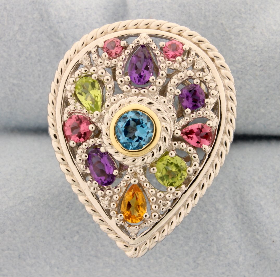 14k gold and Sterling silver ring with multi colored: This fantastic piece is a fashion accessory for every woman, day or night! The beautiful sterling silver gallery style mount is accented with gorgeous Amethyst, Citrine Peridot, and Pink Topaz gemston