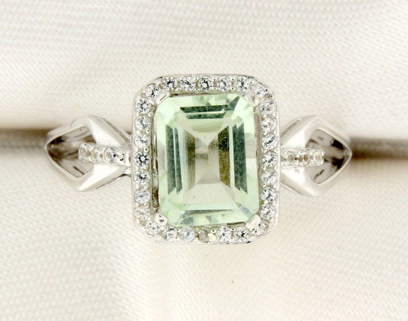Diamond and Green Amethyst Sterling silver ring: An antique cushion-cut genuine Green Amethyst gemstone reigns supreme in this captivating ring for her while white sapphires frame the center and decorate the band. The ring is crafted of sterling sil
