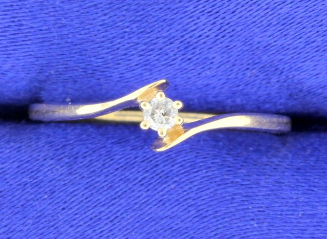 Diamond Promise Ring: A lovely diamond promise ring with center diamond 0.03 carats all set in 10k gold. Size 6 1 g