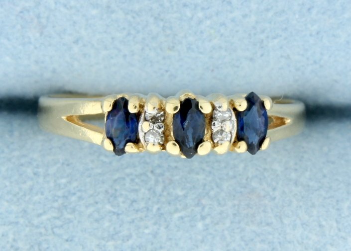 Sapphire & Diamond Ring set in 14k gold: Darling 14k yellow gold ring with Sapphire and diamonds. 4 diamonds and 3 marquise cut Sapphires. 2.0 g Size 6