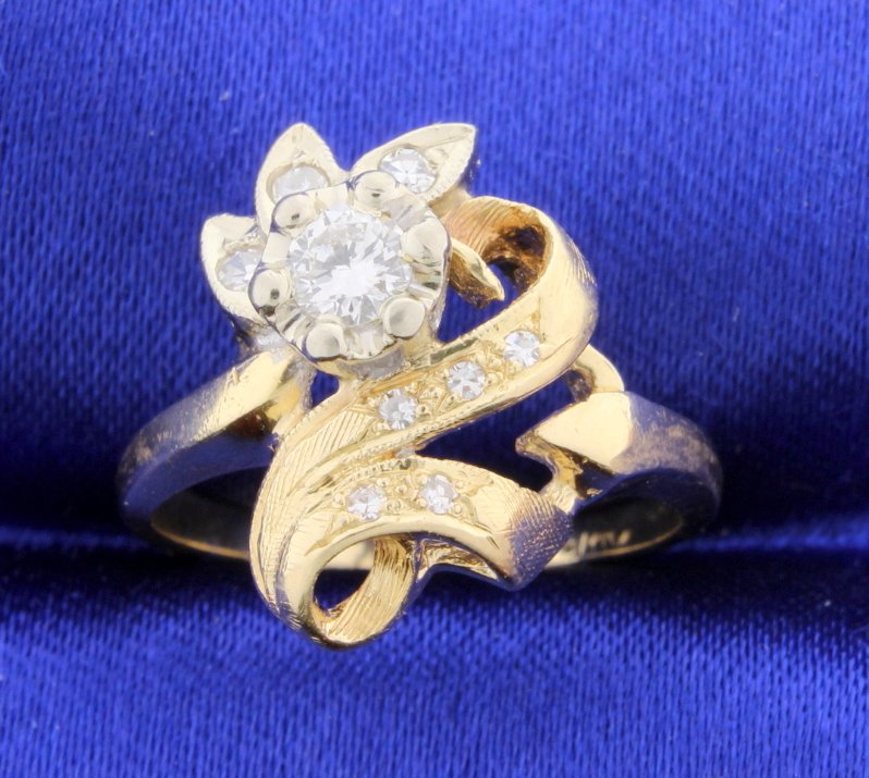 Vintage Diamond Ring: Gorgeous Vintage 14k yellow gold diamond ring. The center diamond is a round brilliant cut 1/4 carat VS2 to SI1 clarity with G color. There are 8 smaller diamonds with a total weight 0.15 carats that 