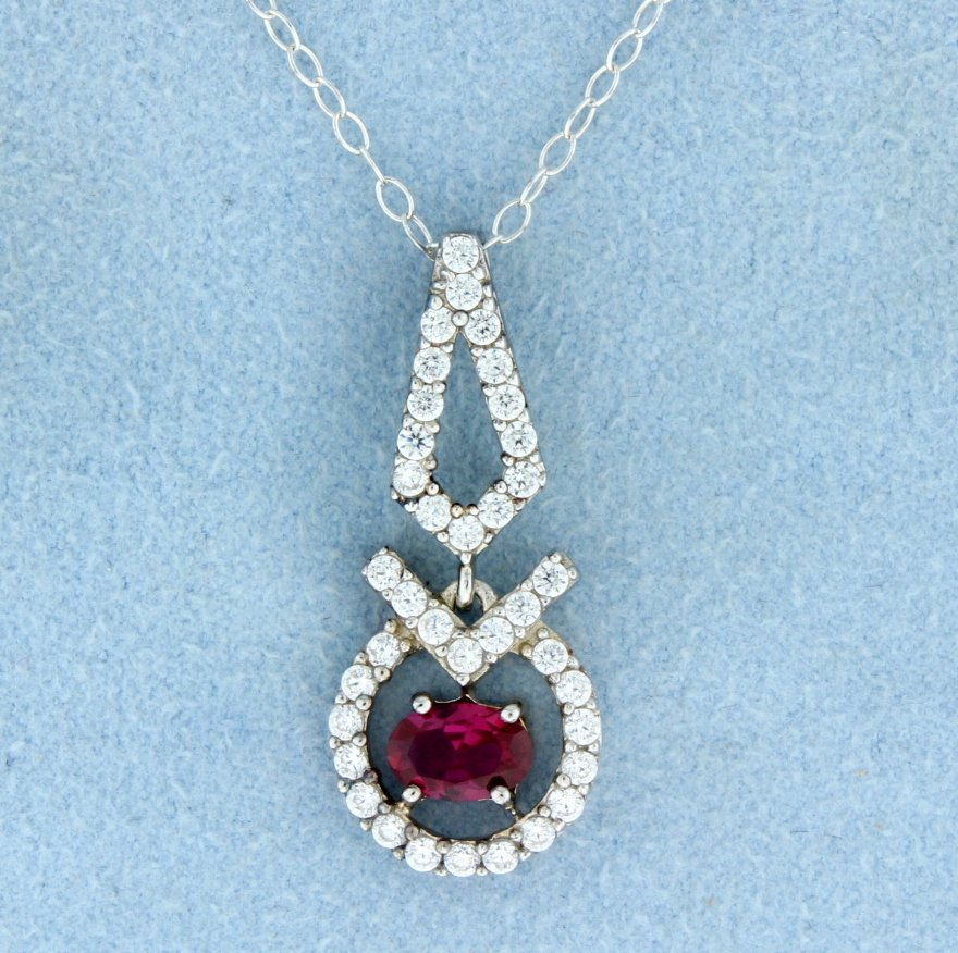 Pendant with lab Ruby and chain: Beautiful sterling silver pendant with gorgeous oval lab Ruby center accented with beautiful white sapphires 2.4g