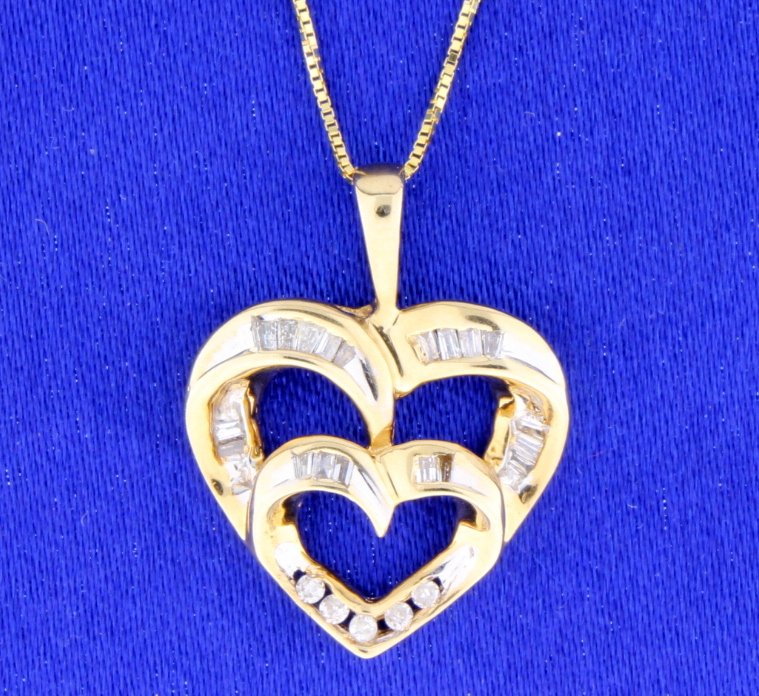 Diamond Heart Necklace: Lovely 14k yellow diamond heart necklace. 1/4 carat of brilliant cut diamonds and baguette diamonds. Diamonds are SI Clarity and G-H-I color. 20" chain also in 14k yellow gold. 3.3g