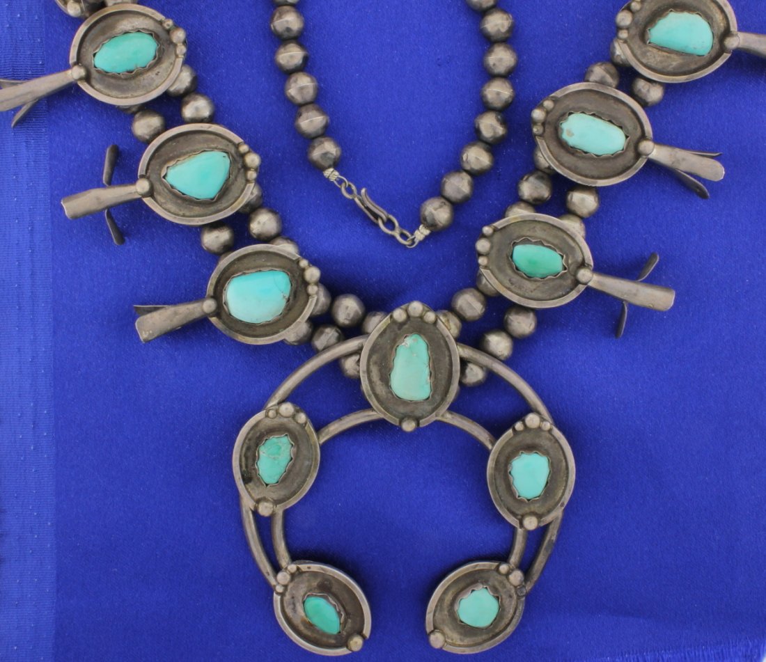 Squash Blossom Necklace: 24" Squash Blossom Necklace in sterling silver and Turquoise shadow box design. Horseshoe 3" x 3 1/4"! Blossoms are almost 1 7/8" long. All Turquoise stones are bezel set. 5 oz. troy.