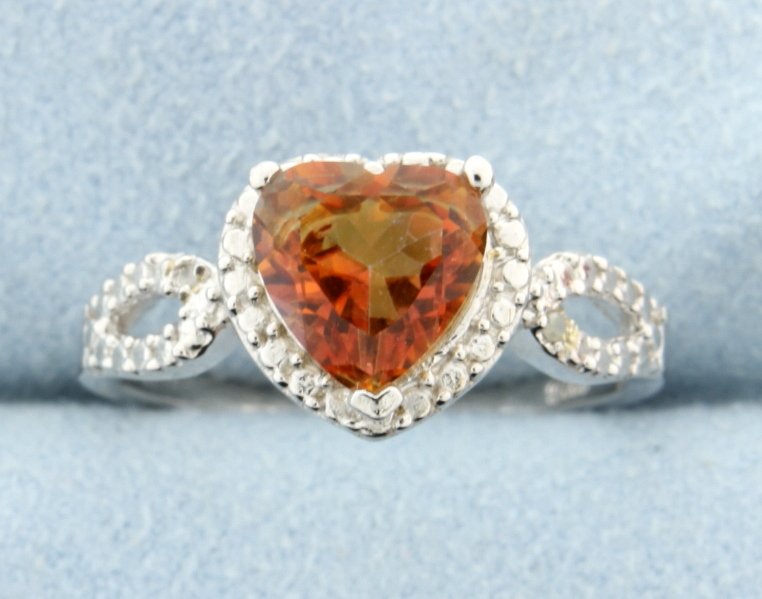 Ring with Azotic gemstone and diamond: Stunning sterling silver ring with beautiful heart shaped Azotic gemstone that offers a vibrant kaleidoscope of colors and accented with a diamond. Size 8 2.9g