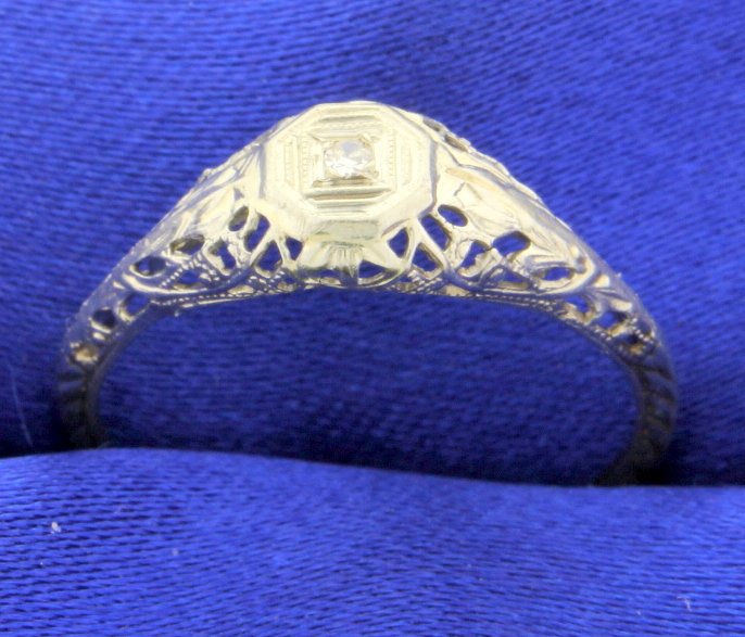 Vintage Diamond Ring: This Vintage diamond ring is very old and set in 18k white gold. The diamond, set in the center, is a single cut and approximately 0.03 carats with SI clarity and H color. The shank is thin but rememb