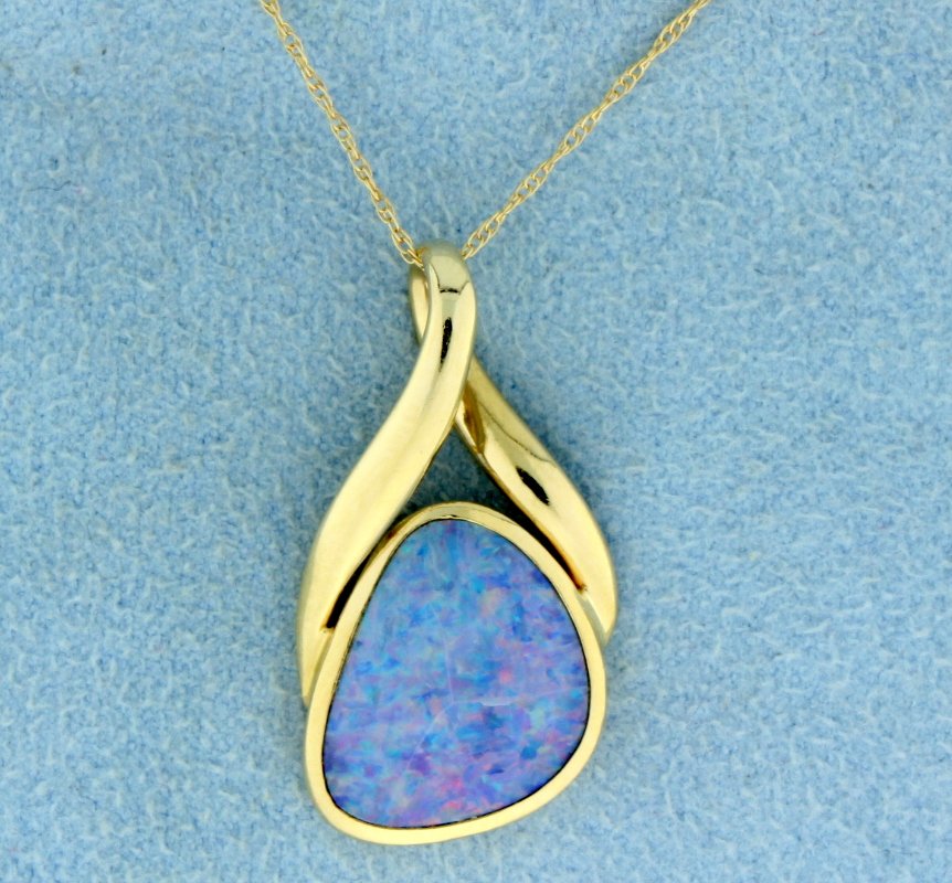 Australian Boulder Opal pendant with chain: Fantastic Australian Boulder Opal set into a 14k yellow gold pendant. The opal offers amazing colors of blues, reds and greens. The pendant is over 1" long and the chain is 14k yellow gold. 2.7g