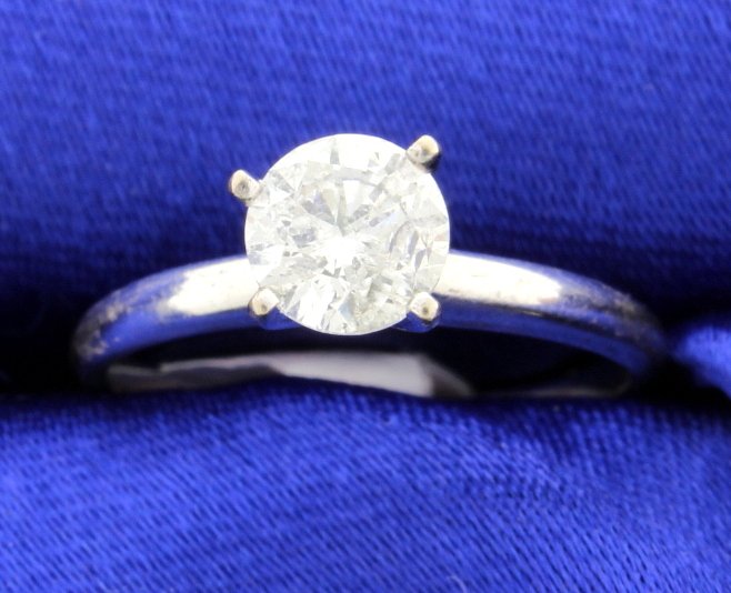 14k white gold diamond solitaire ring: Fantastic 14k white gold ring with stunning 1 carat solitaire round brilliant cut diamond. Diamond measures 6.3mm. I-1,2 clarity and H color. Faces up very well and is very bright. 2.2g Size 7