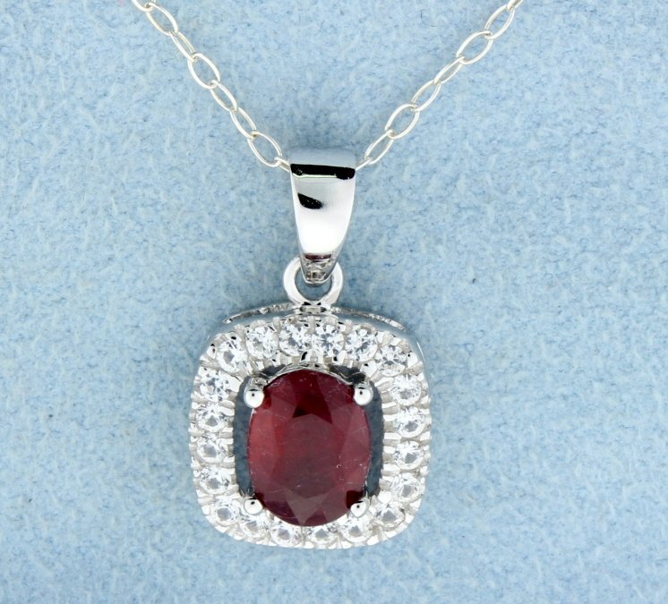 Genuine Ruby pendant with sterling silver chain: Beautiful and classic sterling silver pendant in gorgeous halo style with genuine oval Ruby gemstone at the center accented all around with sparkling white sapphires in cushion like shape and sterling