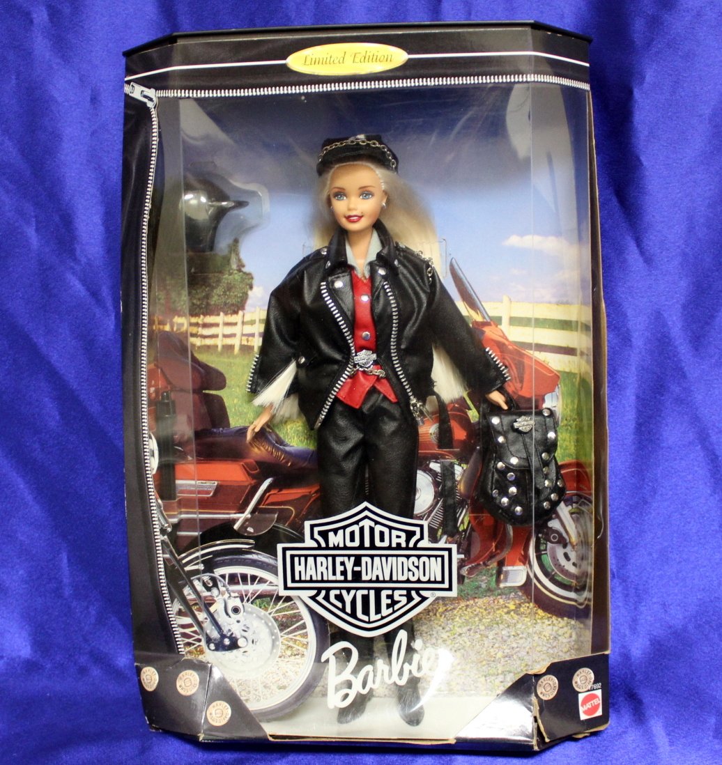 1997 Harley Davidson Limited Edition Barbie: Barbie is a vision of black faux leather, blonde hair and "silver" studs, Harley-Davidson Barbie® doll represents today's free-spirited woman. Her jacket and backpack proudly display the Harley-David