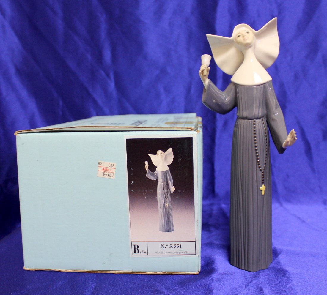 Lladro Figurine Nun "Called to Prayer": This is the elegant Lladro #5551 "Call to Prayer" in a glazed finish. It depicts a nun dressed in blue ringing a bell. Retired in 1993. She is in very good condition with no chips, cracks. She measure