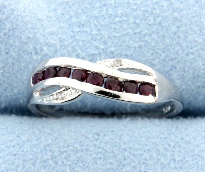 Ruby & Diamond Sterling silver ring: Beautiful and classic this sterling silver rings sparkles with round genuine Ruby gemstones and 0.01 carats of diamonds. A great look! 1.9g Size 7