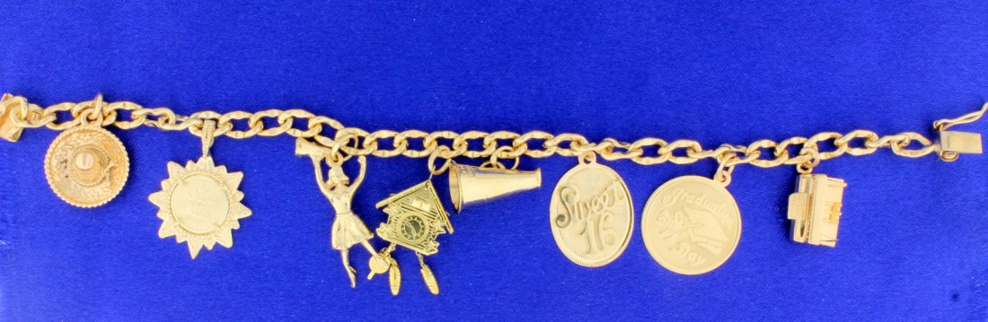 14k gold Charm bracelet: Beautiful charm bracelet that looks like new! The charms are not engraved. Charm bracelets are back in style, add yours today! There are 7 charms, the piece measures 7" long and has a safety catch. 28