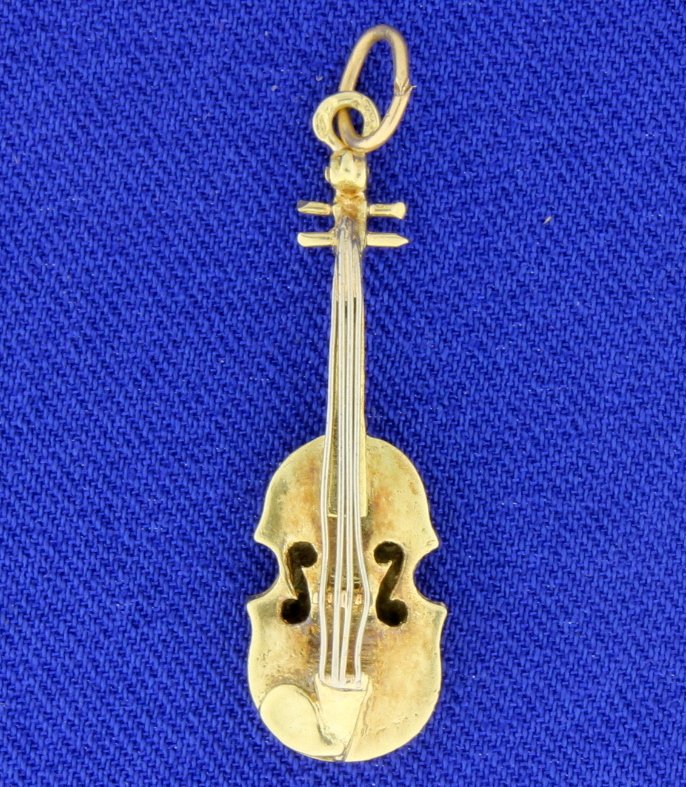 Gold Violin pendant: Beautiful 14k yellow and white gold Violin charm or pendant. The Violin is very detailed with the main parts in yellows gold and then accented with white gold strings! The piece measures 1 1/8" long. 