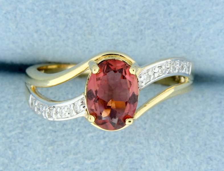 Rhodolite Garnet and diamond ring set in gold: Fantastic Rhodolite Garnet and 10 diamond ring set in 14k tutone gold. Center is a oval Rhodolite Garnet 8mm x 6mm! 3.4g Size 7