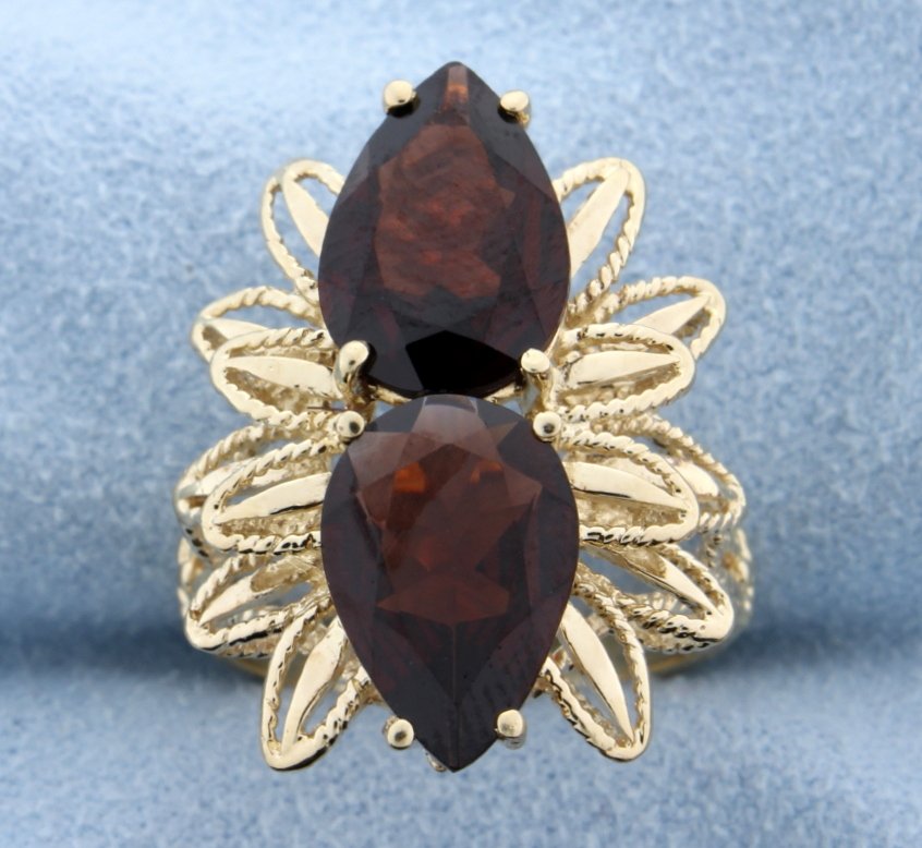 Garnet Ring: This magnificent piece is set in 10k yellow gold and offers a huge look! There are 2 large pear shaped Garnets 12mm x 8.5mm and total approximately 6 carats! Size 7 4.9g