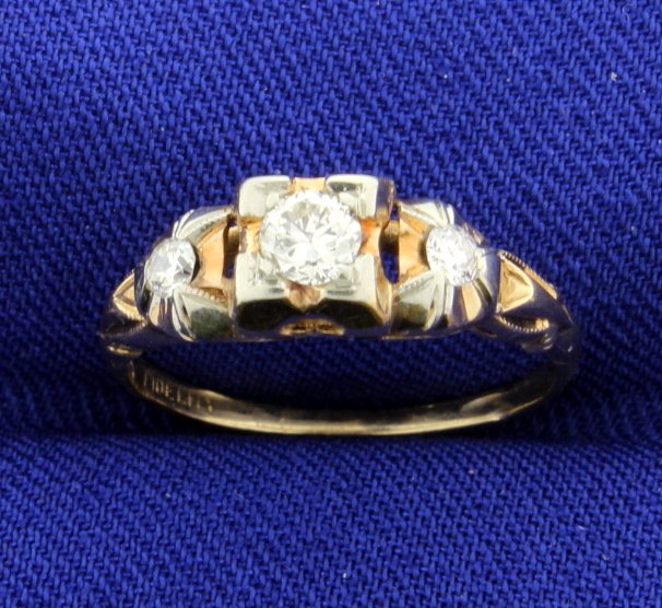 Vintage Diamond Ring: Beautiful Vintage Diamond ring set with 3 brilliant cut diamonds, VS clarity and G color, for a total diamond weight of 0.25 carats. The gold is 14k yellow with some 14k rose gold. Great vintage style