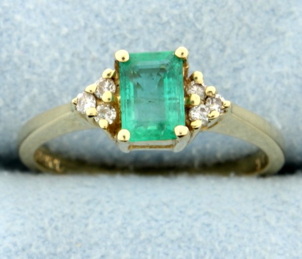 Emerald & Diamond ring: This beautiful 14k yellow gold Emerald and diamond ring offers an emerald cut Emerald at the center! The emerald weighs 0.60 carats and measures 6.07mm x 4.18mm. There are 6 diamonds that total 0.10 c