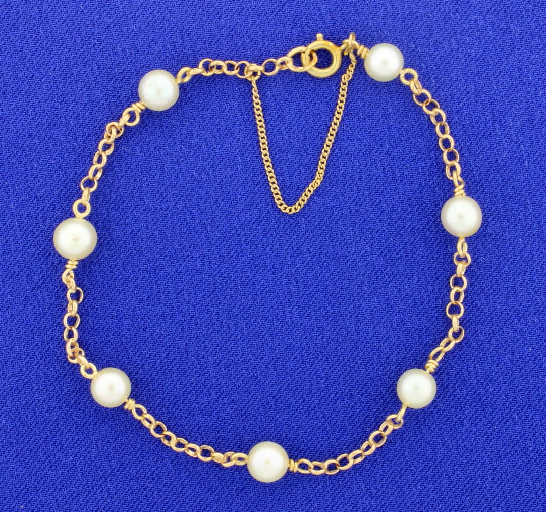 Cultured Pearl & Gold Link Bracelet: We love this bracelet! 7 Cultured pearls measuring 5.75mm each are set between 18k yellow gold links in this 7" long chain. So finely made, it even includes a safety chain! 4.7g