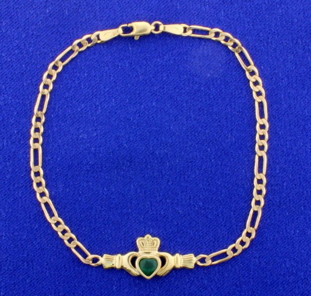 Claddagh Emerald, 7" Ladies Bracelet: 9K gold (.375) made in Europe! The chain is a Figaro style. The catch is a lobster claw clasp. 3.3g