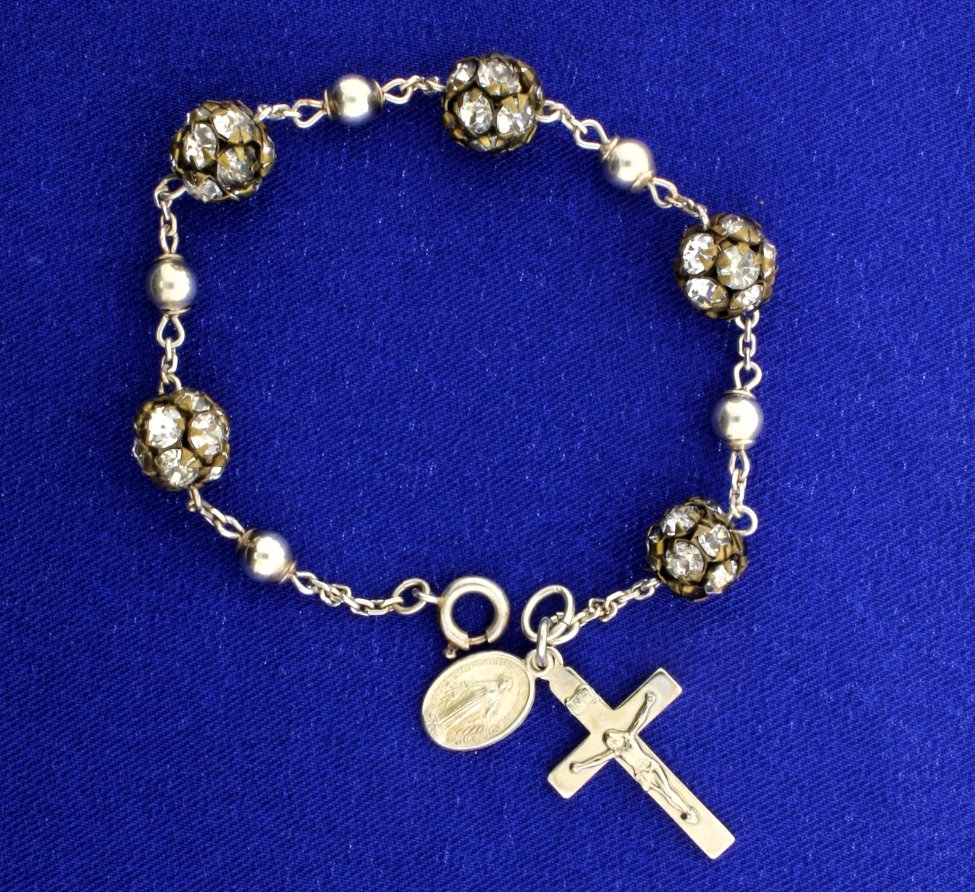 Sterling Silver & Crystal Cross & Madonna Bracelet: 8" long with 2 pendants of Jesus on cross and Mary has 5 decorative balls with crystals. 11.4g