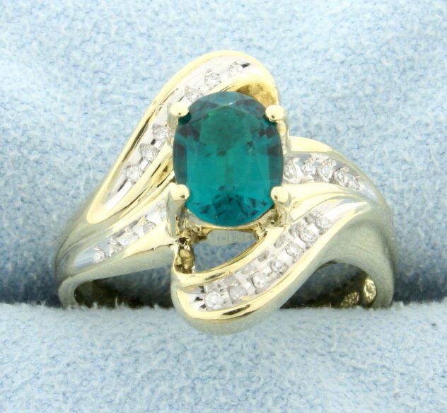 Lab Emerald & Diamond Ring: 10K yellow gold. Lab emerald is 8x6mm approx. 1.5 ct. 1/4 ct. of diamonds T.W. Size 7. 4.2g