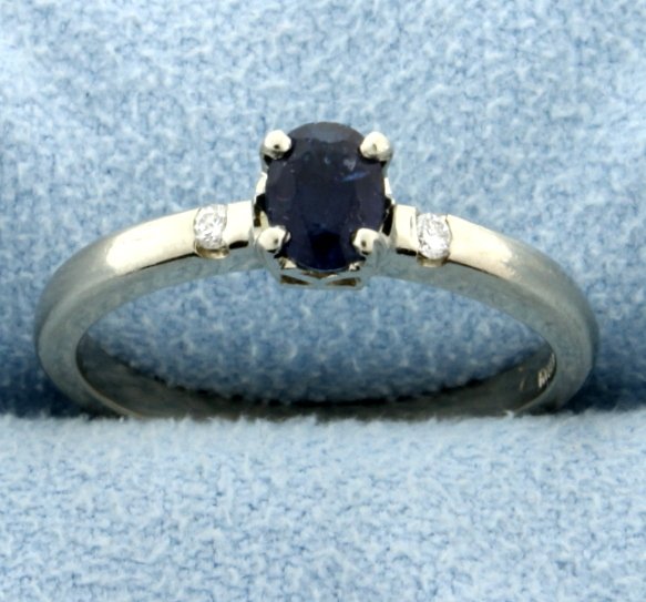 Sapphire and Diamond Ring in 14k White Gold: Sapphire is 5.4x4 mm oval, approximately .5 ct. 2 diamonds .04 ct total weight. Size 6.5 Some minor abrasion on sapphire. 2.7g