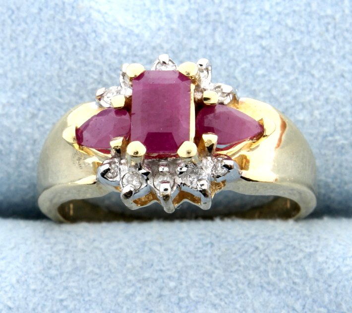 Ruby & Diamond Ring: Lovely Ruby and Diamond ring set in 14k yellow gold. The emerald cut Ruby center is 6 mm x 4.13mm with two pear shaped Rubies on either side. Size 8 5.0g