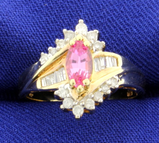 Pink Topaz & Diamond Ring: 1/2 carat of baguette and brilliant cut diamonds, clarity I 1/2 and color "I-J-K". The center vibrant pink topaz measures 8mm x 4mm marquise shape. Approx. weight 0.75 (3/4 ct.) size 7 1/2. 3.9g