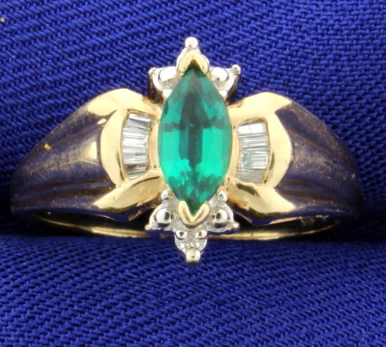 Emerald & Diamond 10K Yellow Gold Ring: The 8mm x 4mm marquise emerald is lab created, possibly a Chatham. There are 1/4 carat of baguette diamonds and round brilliant cuts. Clarity SI-I-1 color "I-J-K" size 7 1/2. 1.9g