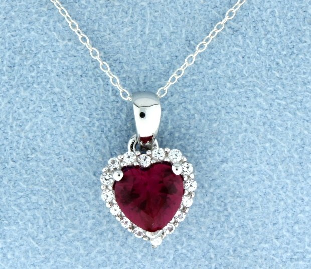 Sterling silver pendant with Lab Ruby: Breath taking sterling silver heart shaped pendant with fantastic lab Ruby heart gemstone set in a Halo of white sapphires that dangles from an 18" sterling silver chain. 2.0g