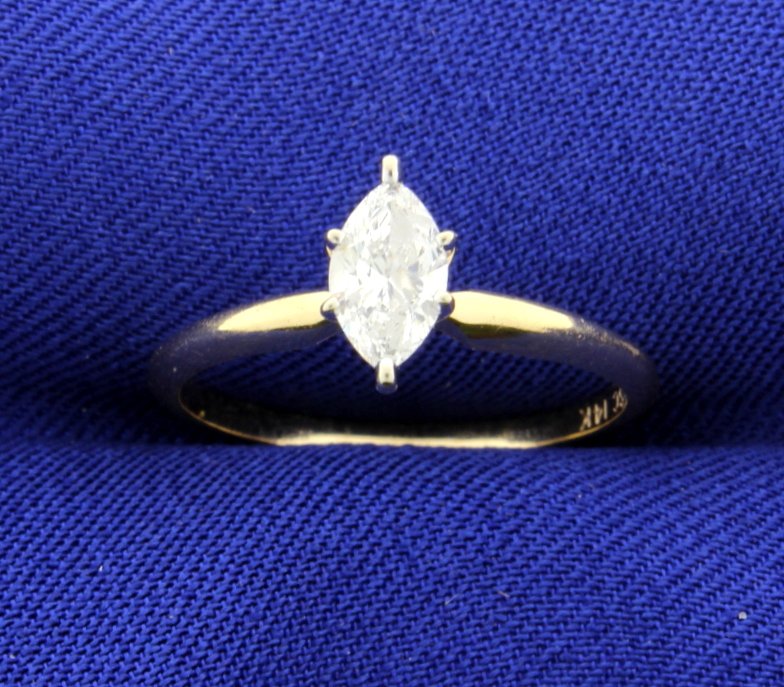 2/5 Carat Diamond Solitaire Ring: The diamond weighs 0.40 carats and is marquise shaped. Clarity SI2, color H. Size 7. 1.9g
