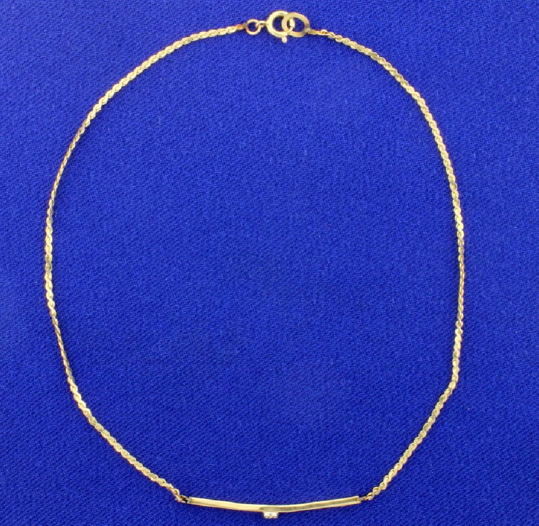 9 5/8 Inch Diamond Anklet: In 14K yellow gold, this anklet contains one 1/2pt diamond, and is 1mm wide. 1.3g