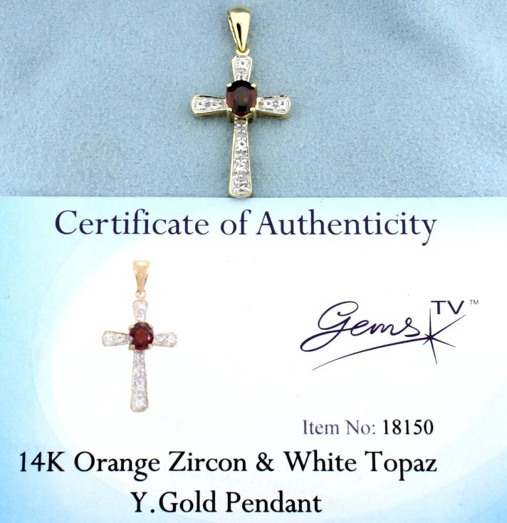 Orange Zircon & White Topaz pendant: Fantastic 14k yellow gold pendant with 1.00 carat total of Orange Zircon and White Topaz gemstones. The oval cut Orange Zircon is 6x5mm and approximately 0.836 carats. There are 9 round white topaz ge