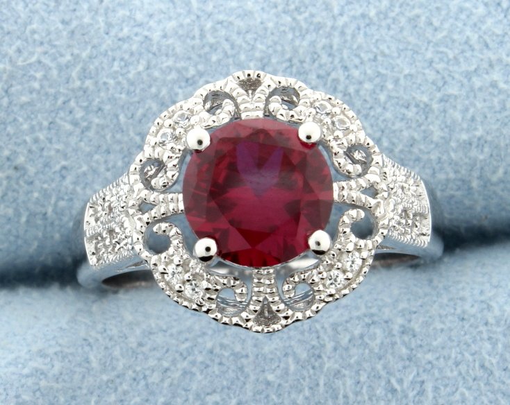 Sterling silver ring with Lab Ruby: Vintage gallery style sterling silver ring with exquisite lab Ruby center gemstone that is accentuated with beautiful white sapphires set meticulously throughout the ring. Size 8 4.1g